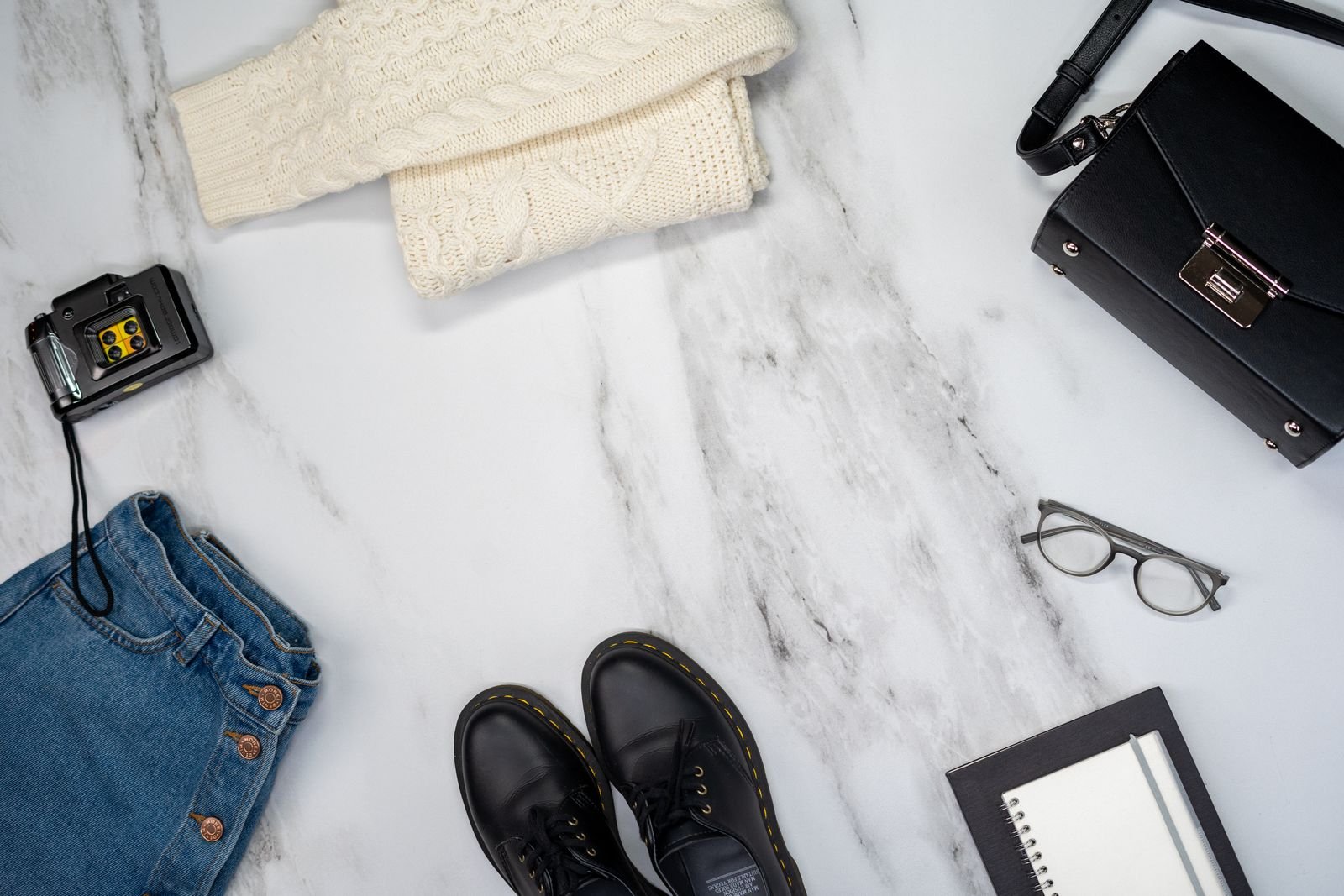 Jeans, shoes and accessories arranged as a casual outfit flat lay