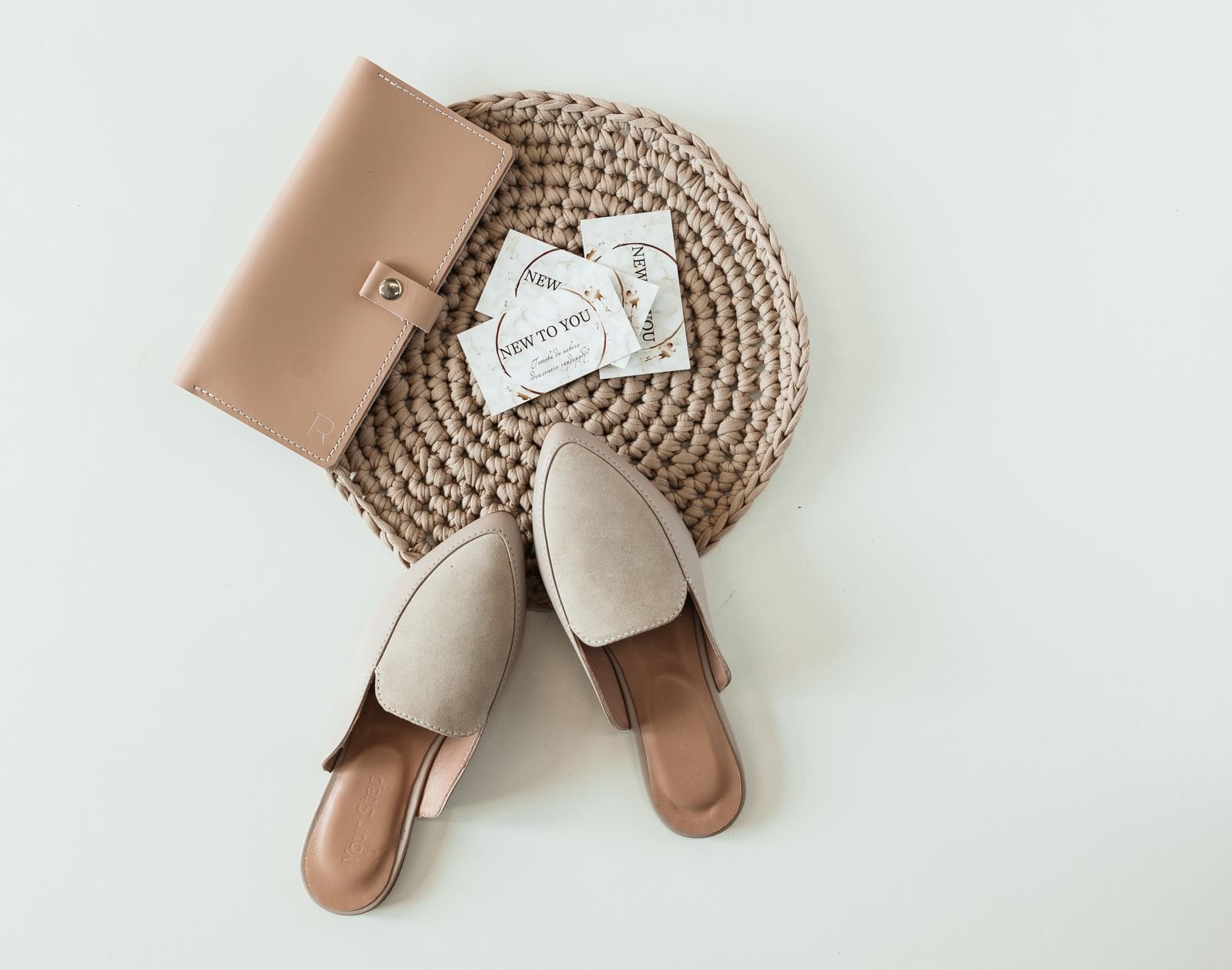 Shoes and a purse arranged on a light surface