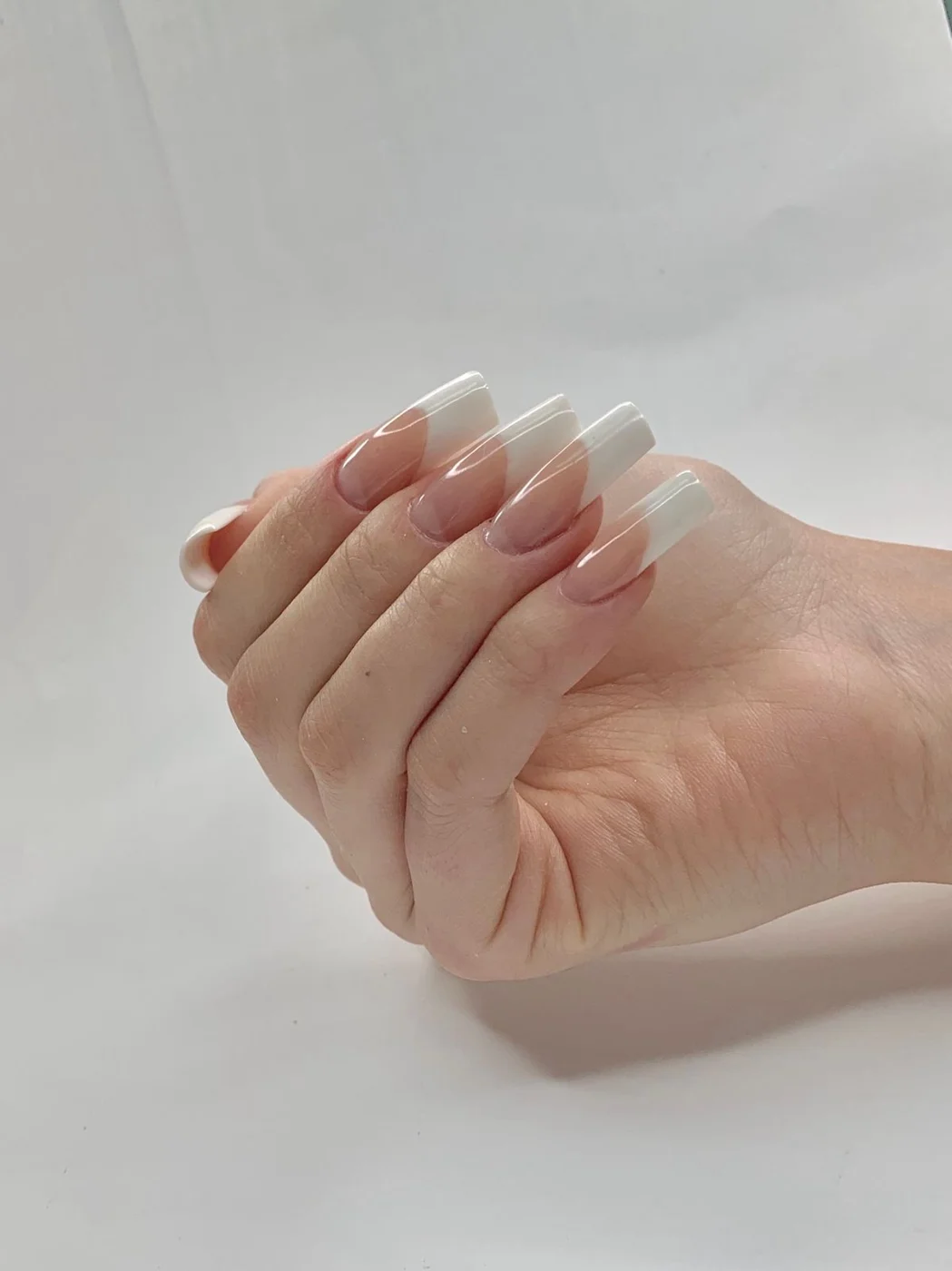 Classic white French tips on long softly squared nails