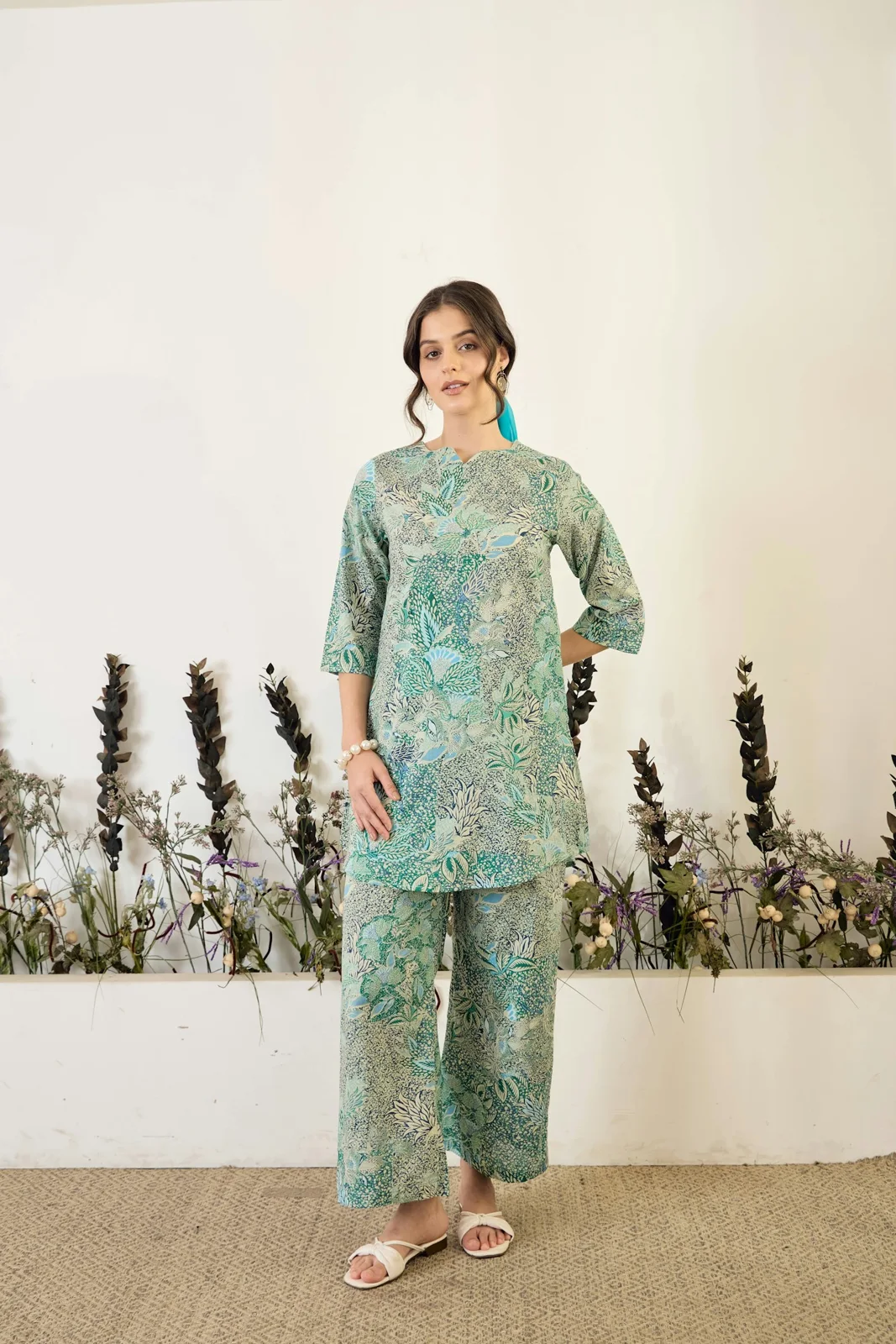 Green floral coordinating tunic and trousers with sandals