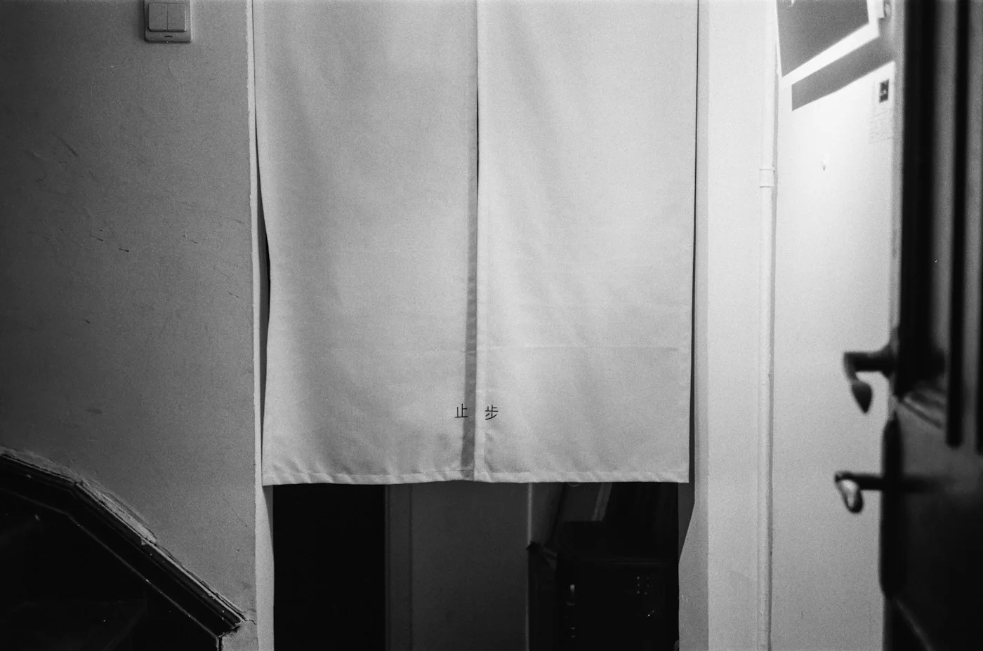 White trousers hanging indoors to show their straight hems